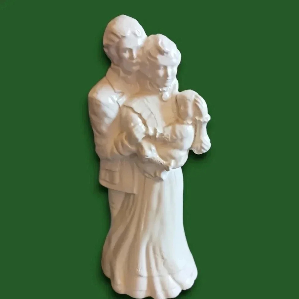 Porcelain figurine man and woman holding baby